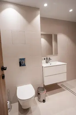 a bathroom with a white toilet and a sink at Stylish Apartment in City Center in Sofia
