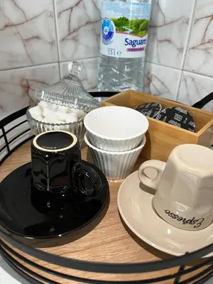 a table with a tray with dishes and a coffee cup at The Nest Above Sofia Studio in Sofia