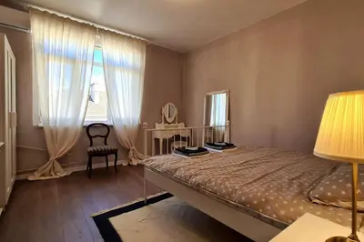 a bedroom with a bed and a chair and a window at Bright 2-BDRM - Stunning Views - Sofia Center in Sofia