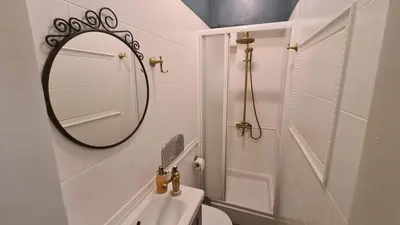 a white bathroom with a mirror and a sink at Bright 2-BDRM - Stunning Views - Sofia Center in Sofia