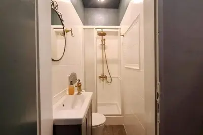 a white bathroom with a sink and a toilet at Bright 2-BDRM - Stunning Views - Sofia Center in Sofia
