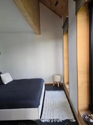 a small bedroom with a bed and a rug at Villa Selya - Private Pool & Mountain View in Selyanin