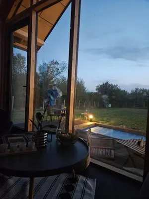 a room with a table and a view of a pool at Villa Selya - Private Pool & Mountain View in Selyanin