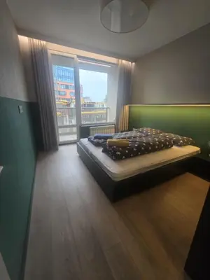 a bedroom with a bed and a large window at Paradise Stay & private parking in Sofia