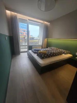 a bedroom with a bed in a room with a window at Paradise Stay & private parking in Sofia