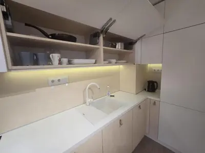 a kitchen with white cabinets and a sink at Paradise Stay & private parking in Sofia