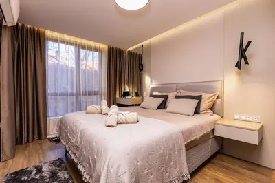 a bedroom with a large bed and a large window at TOP Center apt 'Pemena' FREE Private Parking in Plovdiv