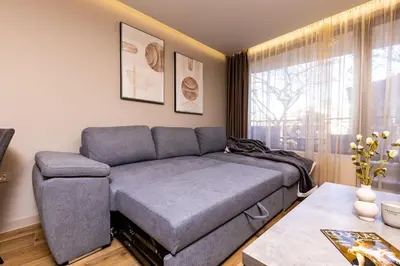 a living room with a couch and a table at TOP Center apt 'Pemena' FREE Private Parking in Plovdiv