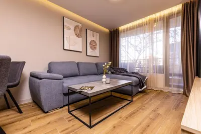 a living room with a couch and a table at TOP Center apt 'Pemena' FREE Private Parking in Plovdiv