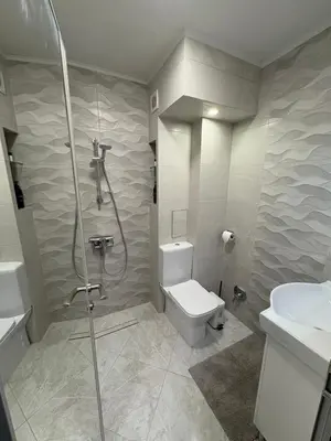 a bathroom with a shower and a toilet and a sink at Nikea apart 1 in Velingrad