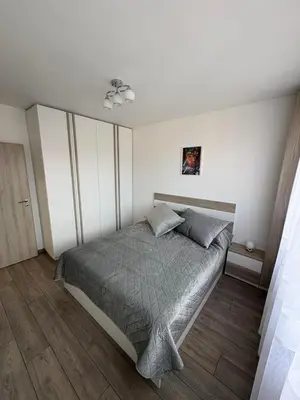 a bedroom with a bed in a white room at Nikea apart 1 in Velingrad