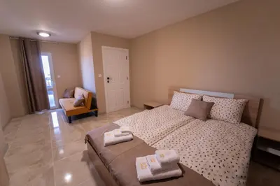 a bedroom with a bed with two towels on it at Къща за гости Катлея in Hisarya