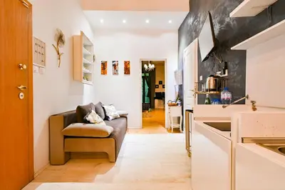 a living room with a couch and a kitchen at Luxory in Sofia