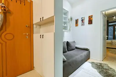 a living room with a couch next to a door at Luxory in Sofia