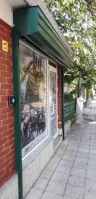 a store window with a picture of a man wearing a crown at Iztok House Apartment in Sofia