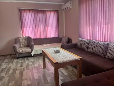 a living room with a couch and a table at Речен шепот in Kalofer