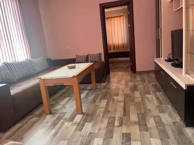 a living room with a table and a couch at Речен шепот in Kalofer