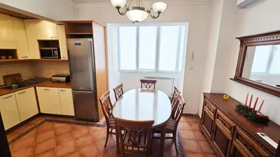 a kitchen with a table and chairs and a refrigerator at The Executive Escape Sofia in Sofia