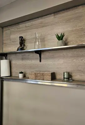 a shelf with plants and a glass bottle on it at Philipopolis Stay in Plovdiv