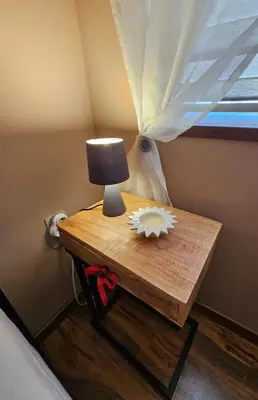 a table with a lamp and a flower on it at Philipopolis Stay in Plovdiv