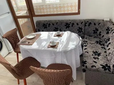 a table and chairs with a white table cloth on it at Панорама in Panagyurishte