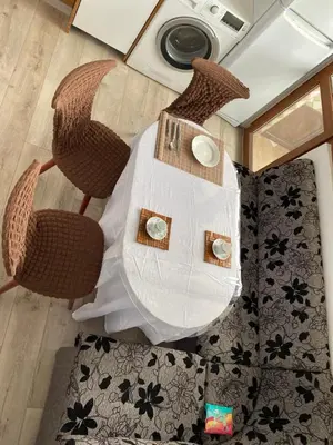 an overhead view of a table and chairs with a white table at Панорама in Panagyurishte