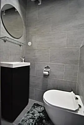 a bathroom with a toilet and a sink and a mirror at Oblivion in Velingrad