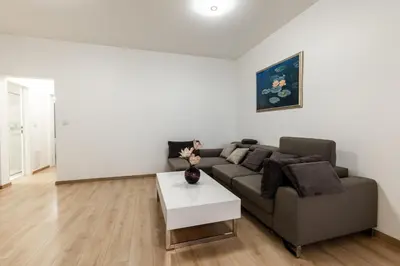 a living room with a couch and a table at Finest 3BR Downtown in Sofia