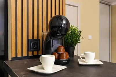 a coffee maker sitting on a table with two cups at Central Chic 1BD Apt Near Kapana by Flat Manager in Plovdiv