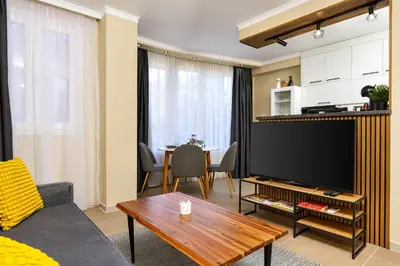 a living room with a television and a table at Central Chic 1BD Apt Near Kapana by Flat Manager in Plovdiv
