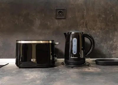 two black appliances are sitting on a counter at Central Chic 1BD Apt Near Kapana by Flat Manager in Plovdiv
