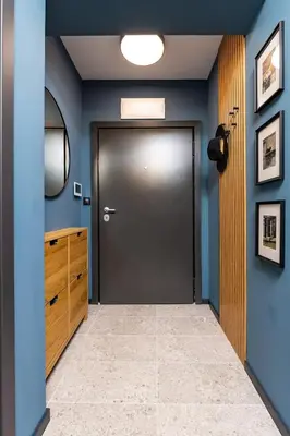a hallway with a door and blue walls at Stylish apt 'Photo Booth' with an amazing location in Plovdiv