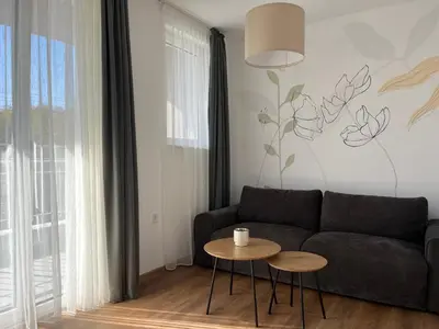 a living room with a couch and a table at Villa YoSi in Sapareva Banya