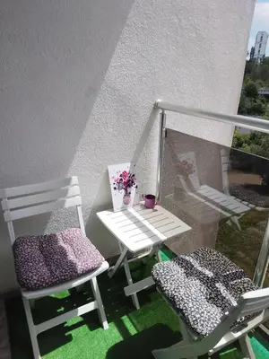 two chairs and a table on a balcony at Your Sweet Home in Sofia