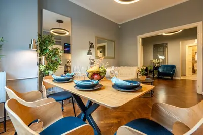 a dining room with a wooden table and chairs at VIP APARTMENT ViTOSHA 69 blvd 3 bdrm - TOP LOCATION in Sofia