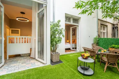 a patio with green grass and a table and chairs at VIP APARTMENT ViTOSHA 69 blvd 3 bdrm - TOP LOCATION in Sofia