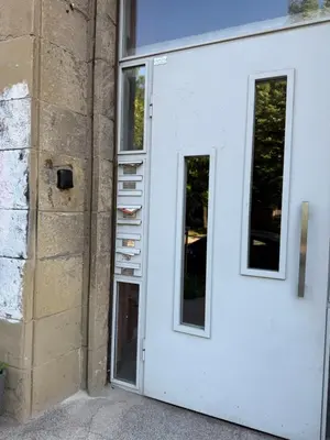 a white door with two windows next to a building at Луксозен арт апартамент в близост до центъра на града in Sofia