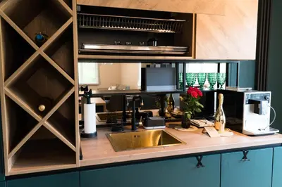 a kitchen counter with a sink and a microwave at Луксозен арт апартамент в близост до центъра на града in Sofia