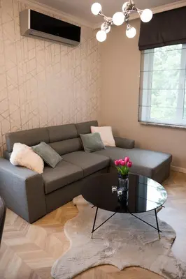a living room with a couch and a glass table at Луксозен арт апартамент в близост до центъра на града in Sofia