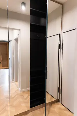 a black closet with glass doors in a room at Луксозен арт апартамент в близост до центъра на града in Sofia