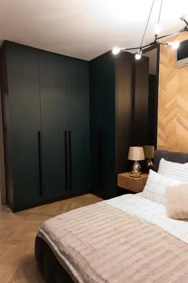 a bedroom with green cabinets and a large bed at Луксозен арт апартамент в близост до центъра на града in Sofia