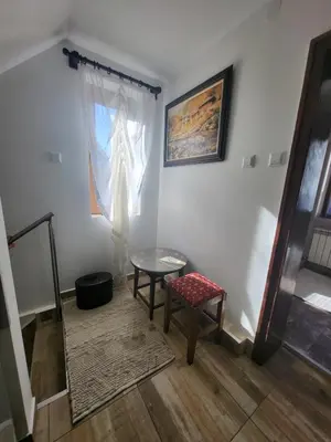 a room with a table and a chair and a window at Йони in Teteven