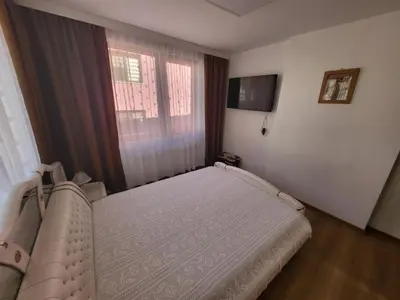 a small bedroom with a bed and a window at Йони in Teteven