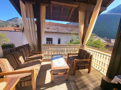 a porch with couches and a table and a view at Йони in Teteven