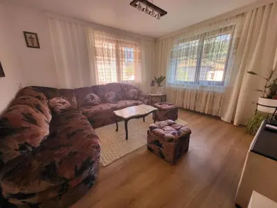 a living room with a couch and a table at Йони in Teteven