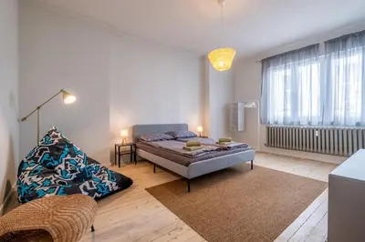 a bedroom with a bed and a couch in a room at Spacious & Central 2BR with Terrace, Cozy & Modern by Flat Mаnager in Sofia