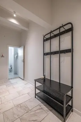 a room with a black shelf on the wall at Spacious & Central 2BR with Terrace, Cozy & Modern by Flat Mаnager in Sofia