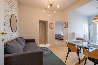 a living room with a couch and a table at Spacious & Central 2BR with Terrace, Cozy & Modern by Flat Mаnager in Sofia