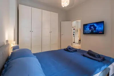 a bedroom with a blue bed with towels on it at Spacious & Central 2BR with Terrace, Cozy & Modern by Flat Mаnager in Sofia