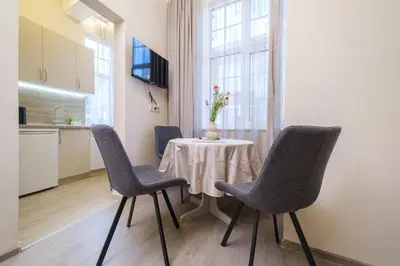 a dining room with a table and four chairs at Cozy Corner-Heart of Plovdiv in Plovdiv